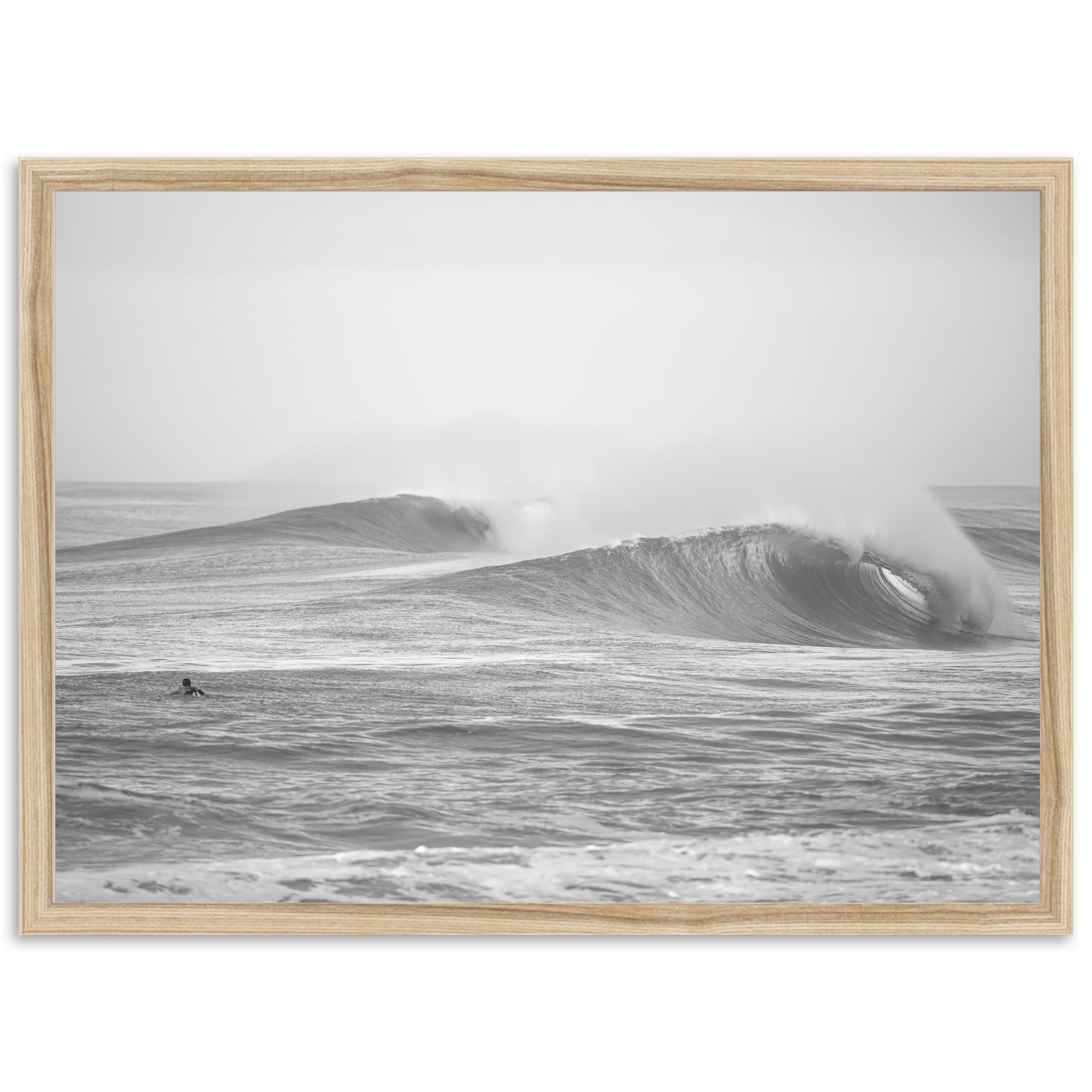 a black and white photo of a surfer riding a wave