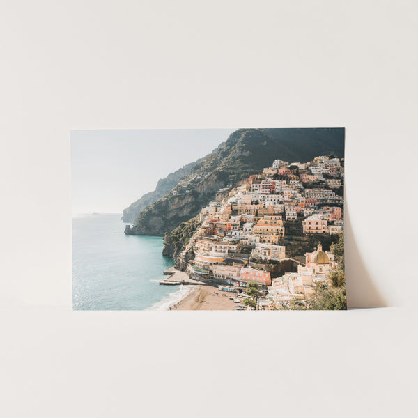 a picture of a town on a cliff by the ocean