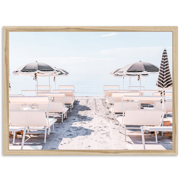 a picture of some chairs and umbrellas on the beach