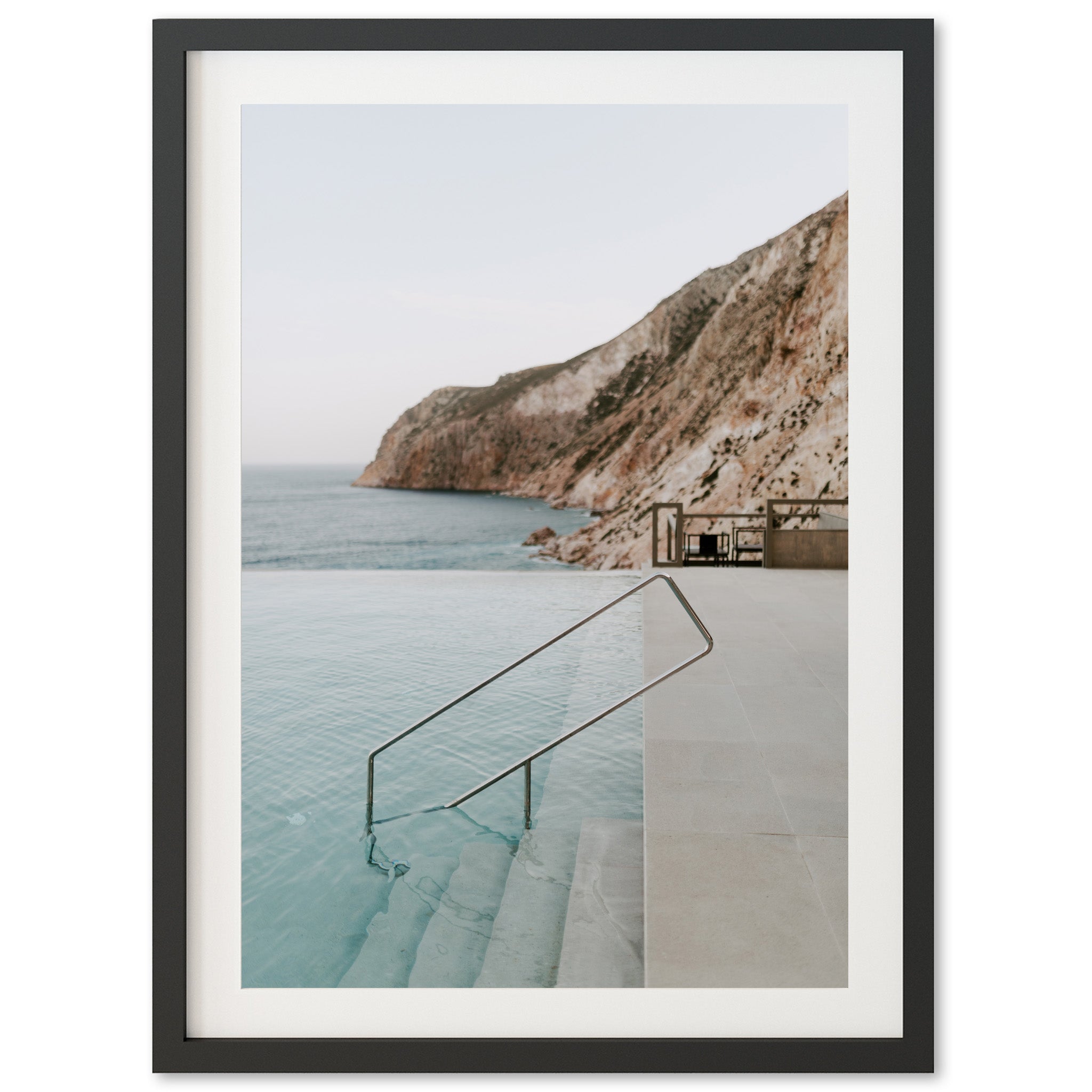 a framed photo of a pool with stairs leading to the water