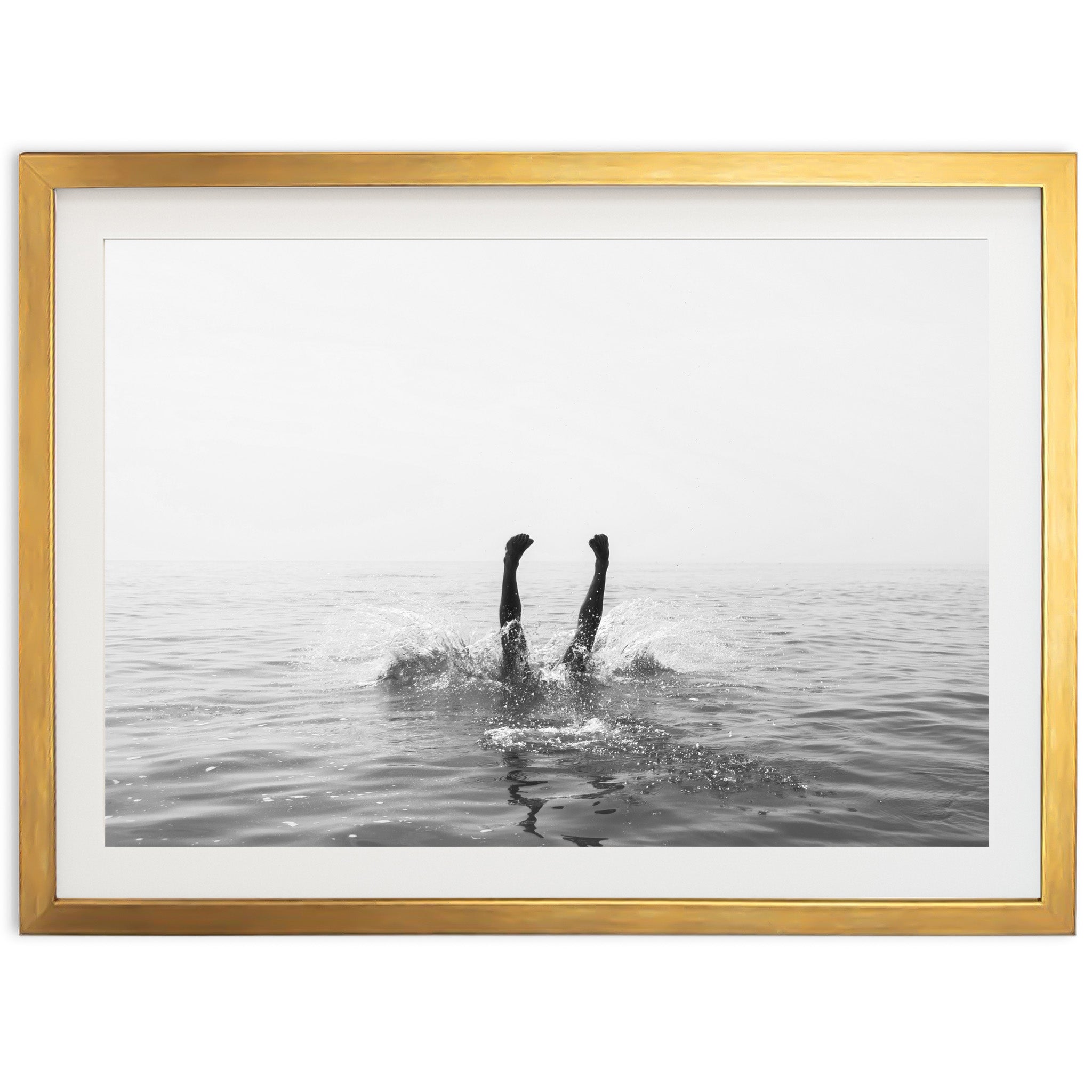 a black and white photo of a person swimming in the ocean