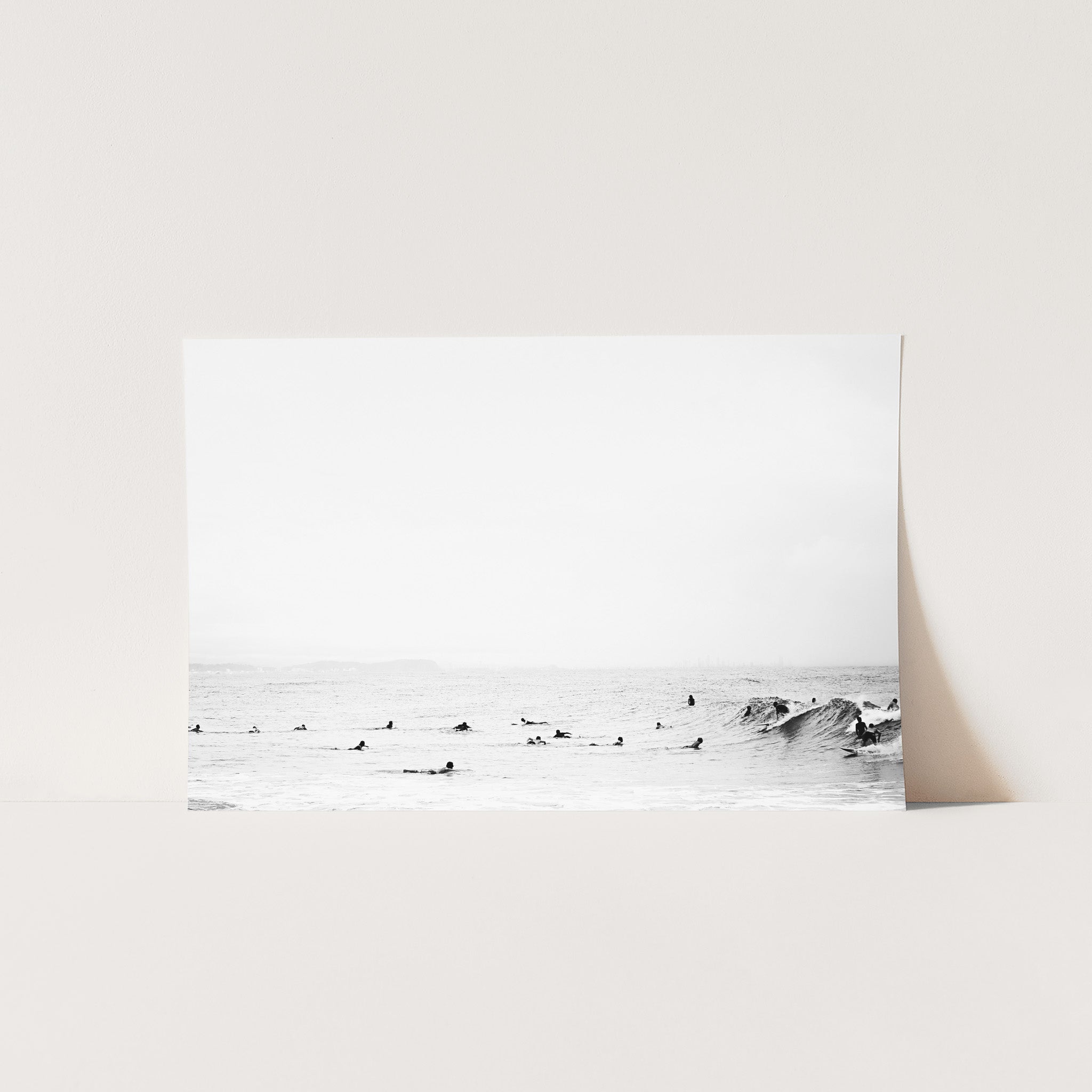 a black and white photo of surfers in the ocean