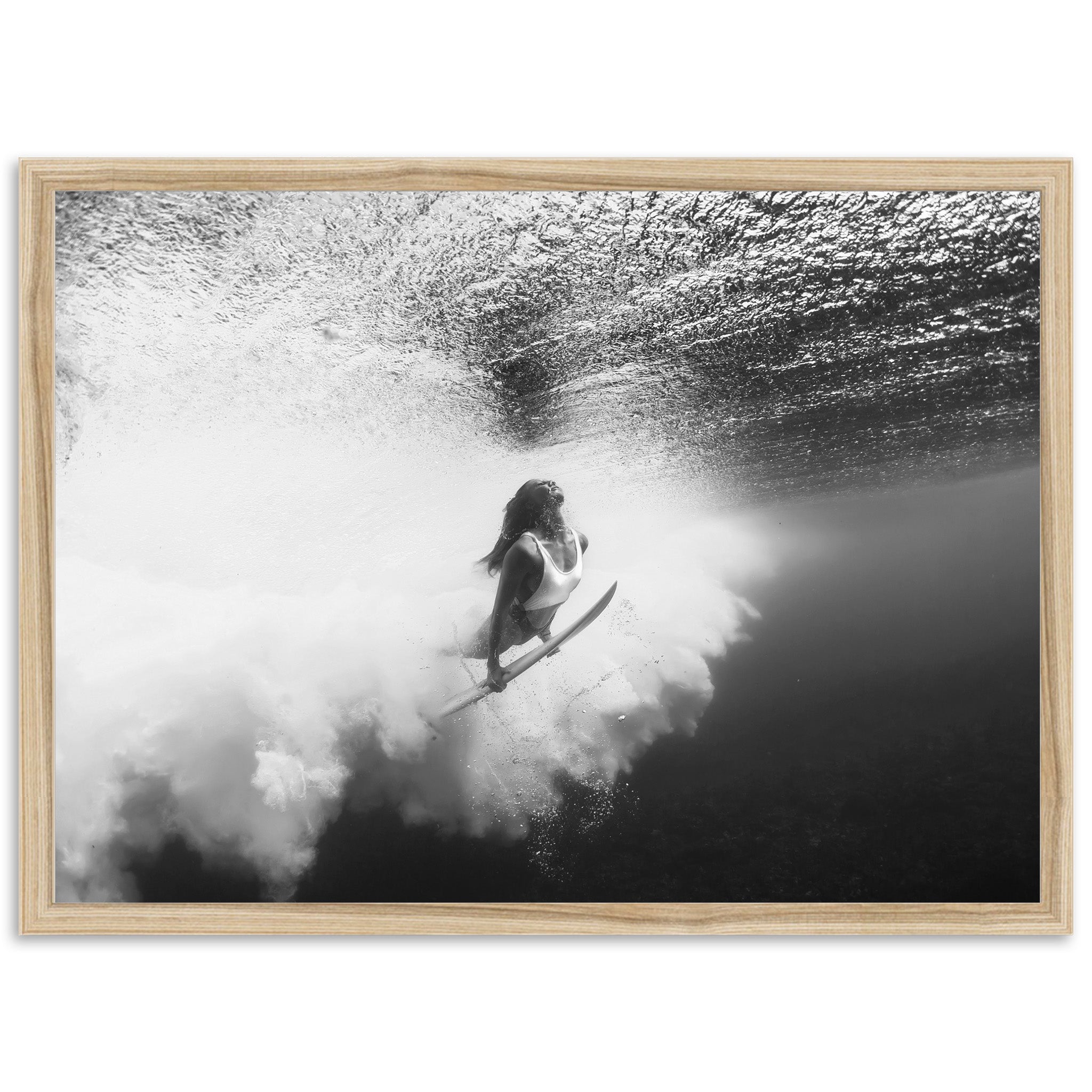 a black and white photo of a woman on a surfboard