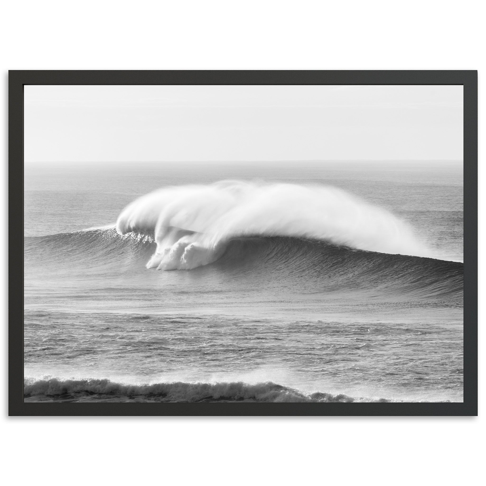 a black and white photo of a large wave