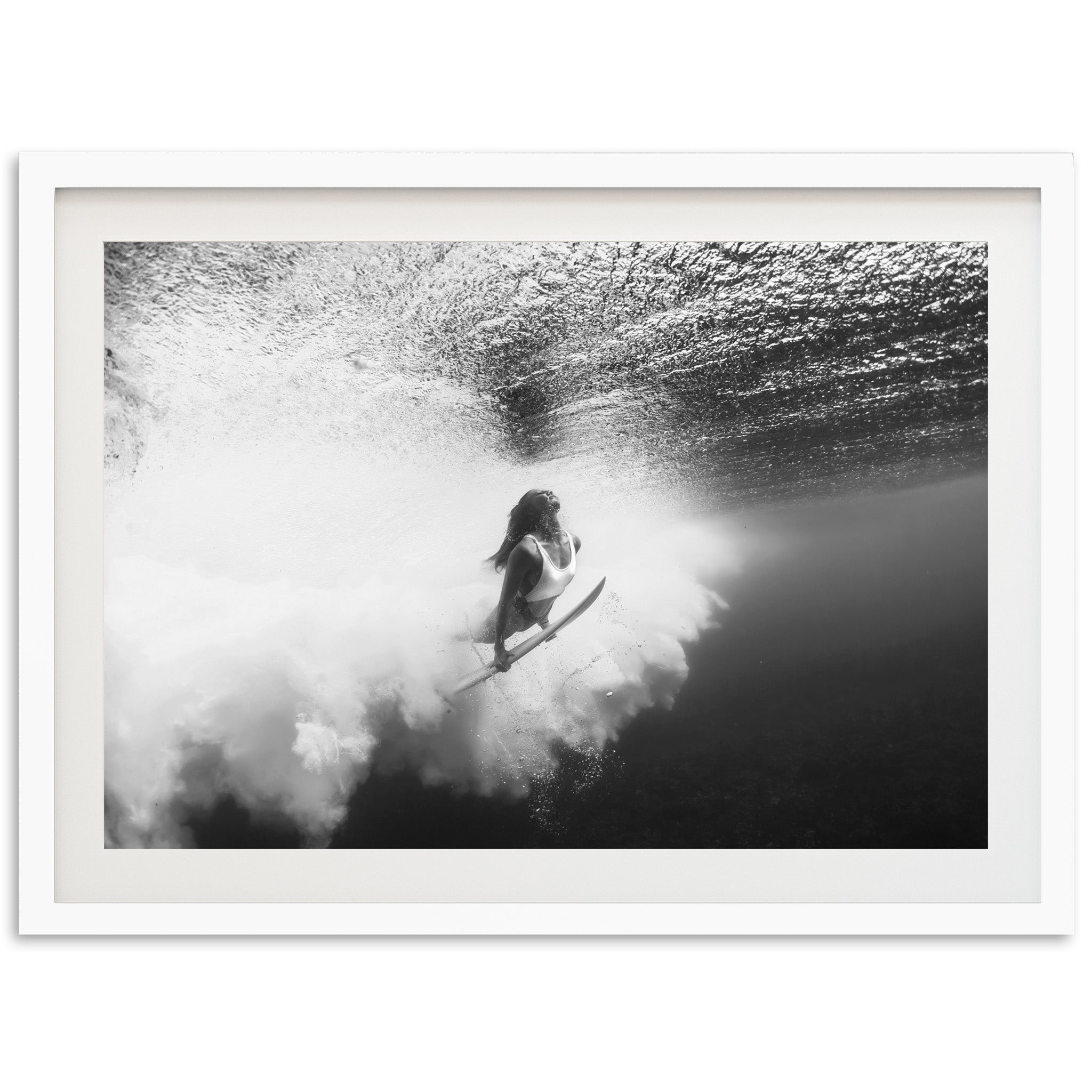 a black and white photo of a person on a surfboard