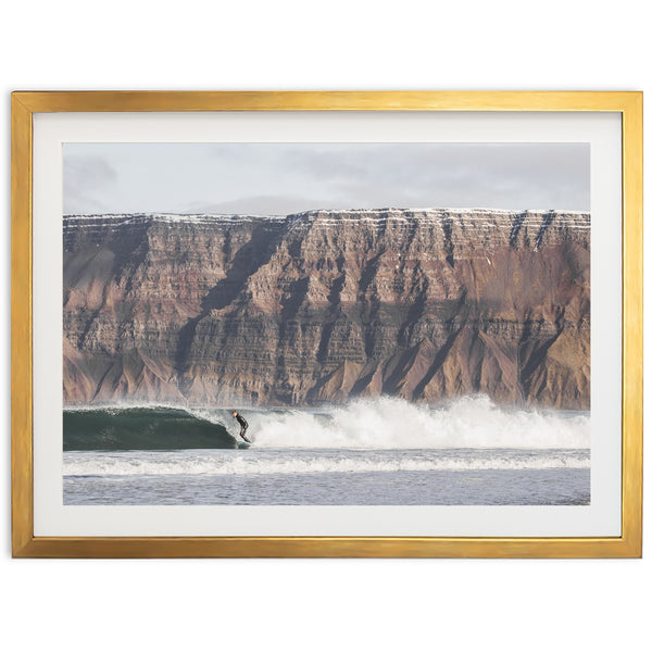 a man riding a wave on top of a surfboard