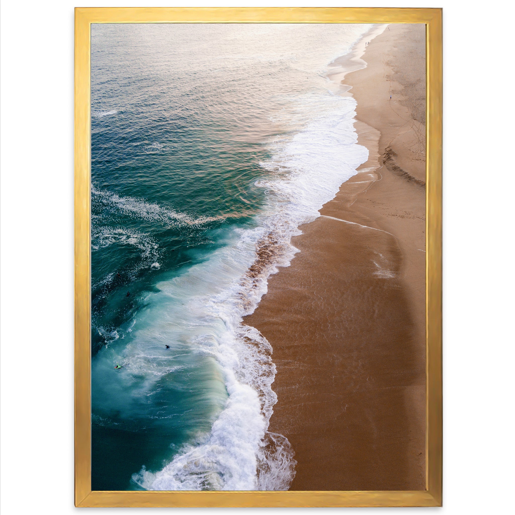 an aerial view of a beach with waves coming in