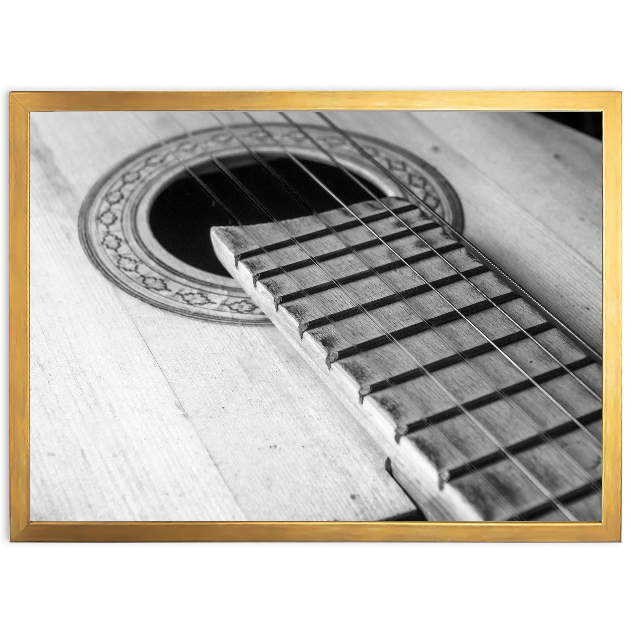 a black and white photo of an acoustic guitar