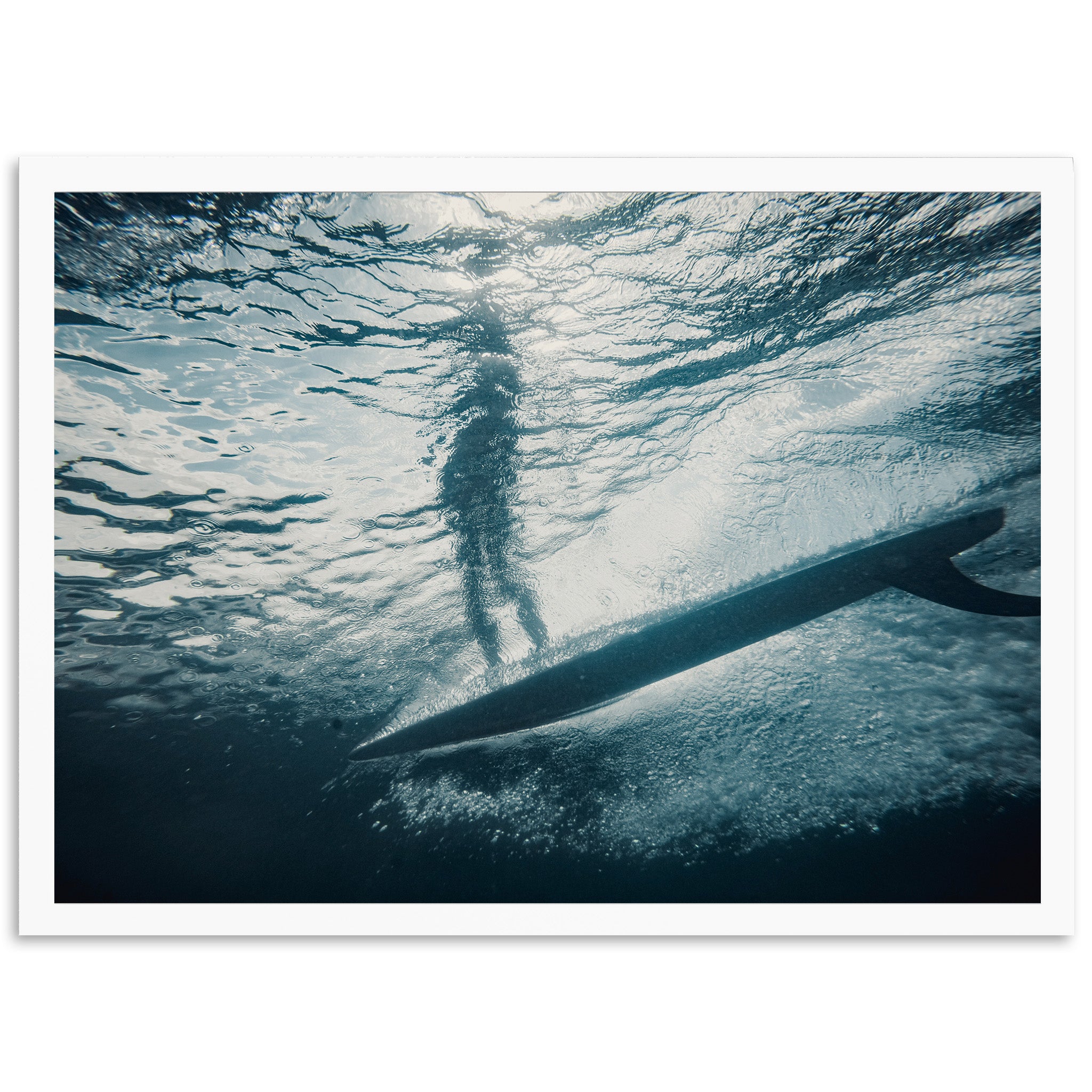 a person standing on a surfboard in the water