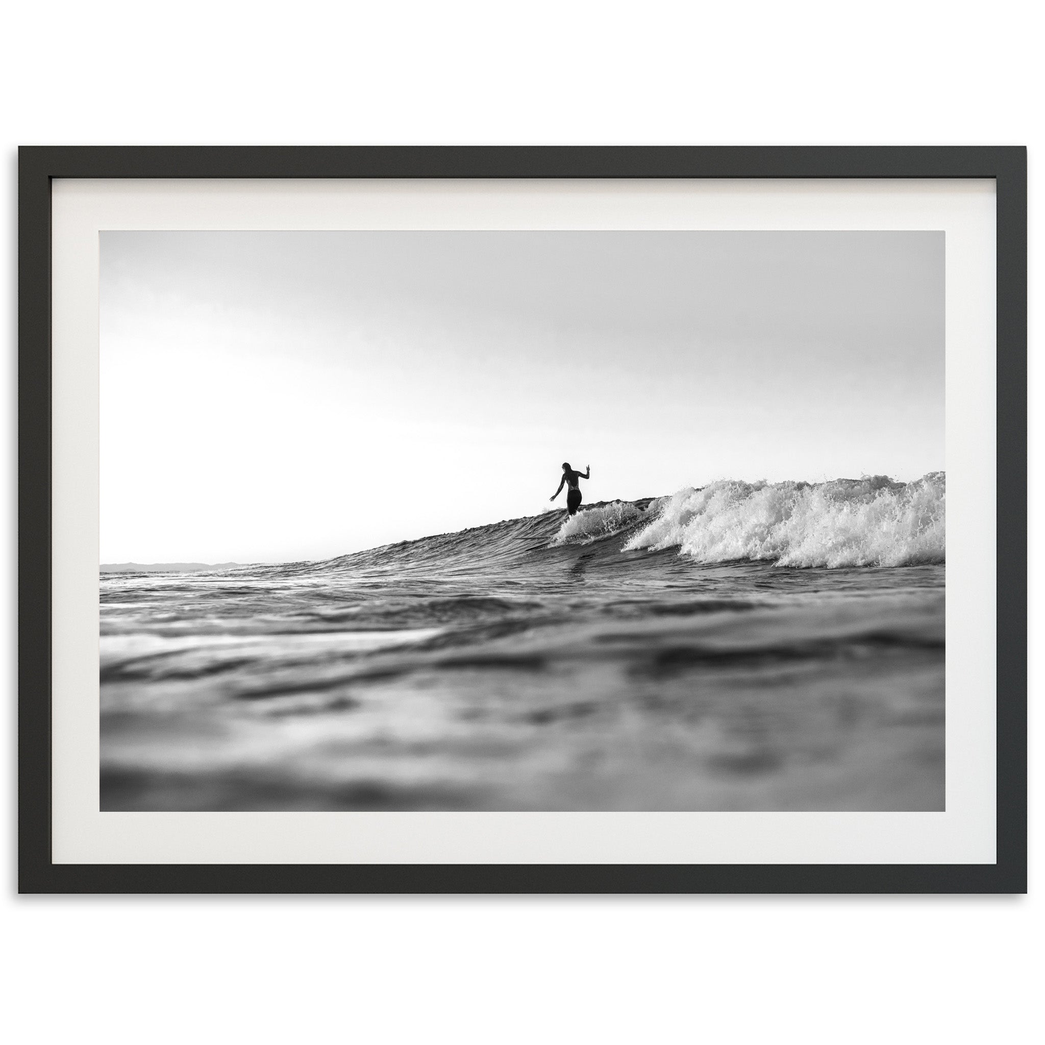 a man riding a wave on top of a surfboard