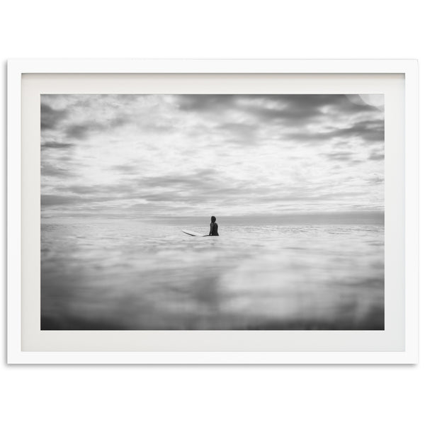 a black and white photo of a person on a surfboard