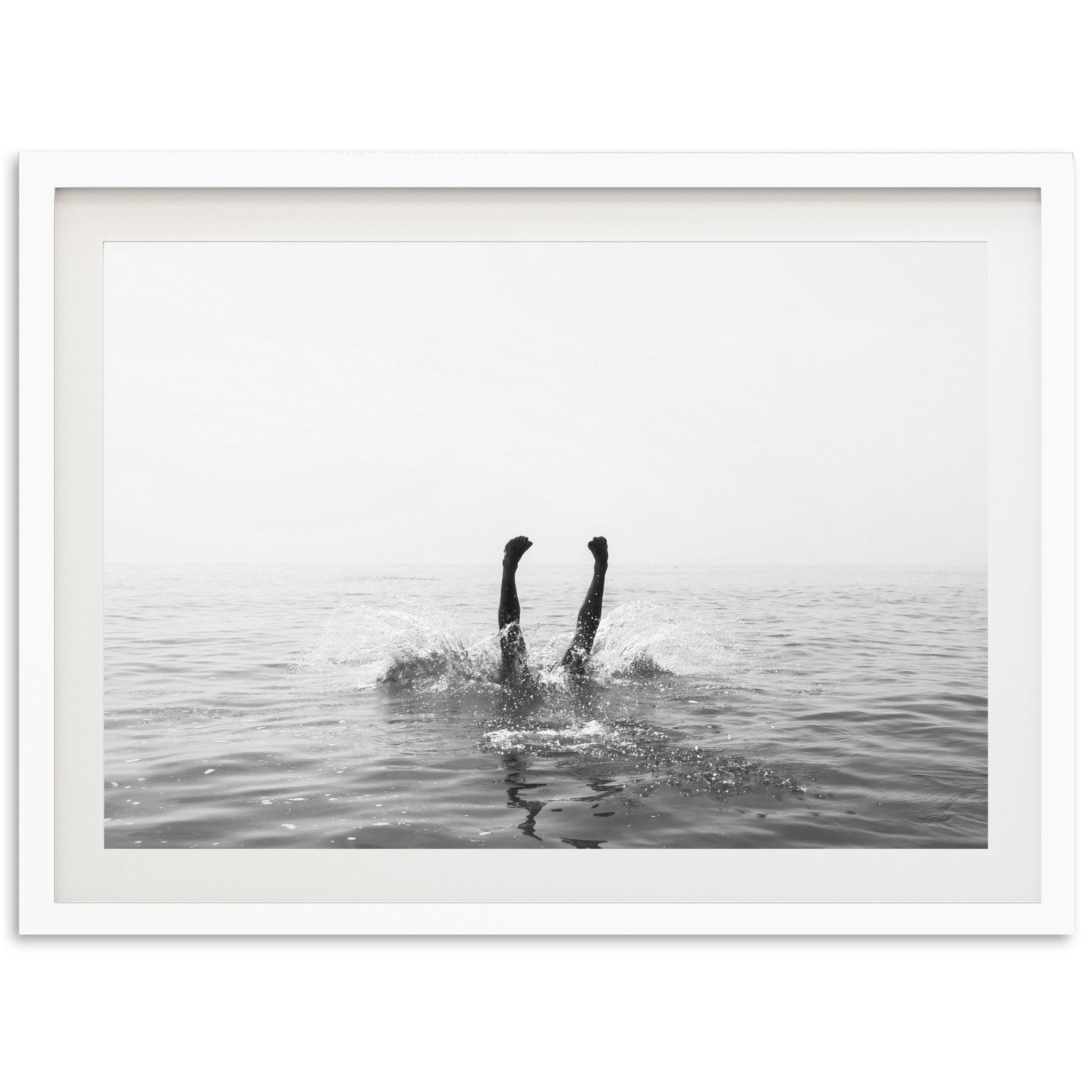 a black and white photo of a person swimming in the ocean