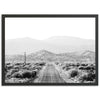 a black and white photo of a road in the desert