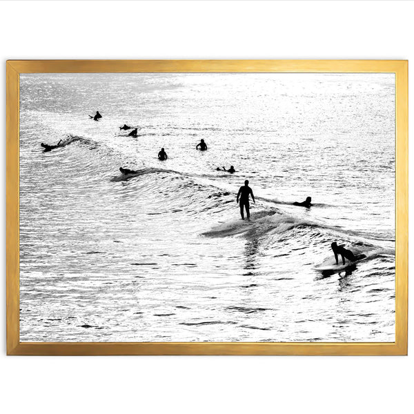 a black and white photo of surfers in the ocean