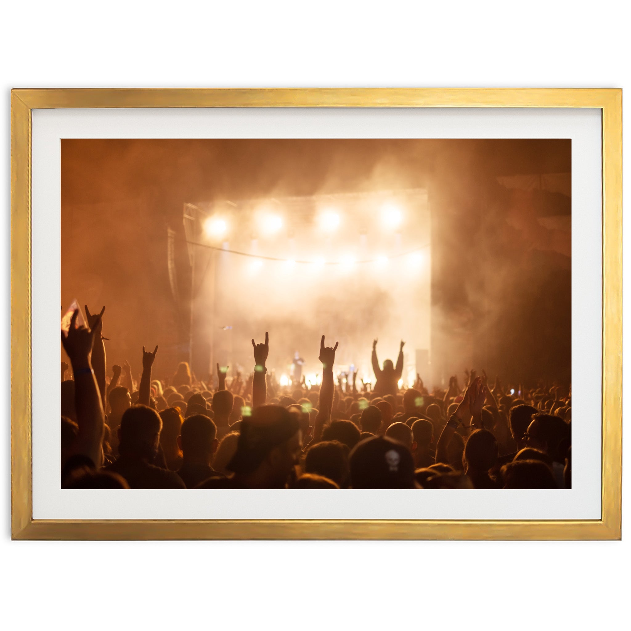 a crowd of people at a concert with their hands in the air