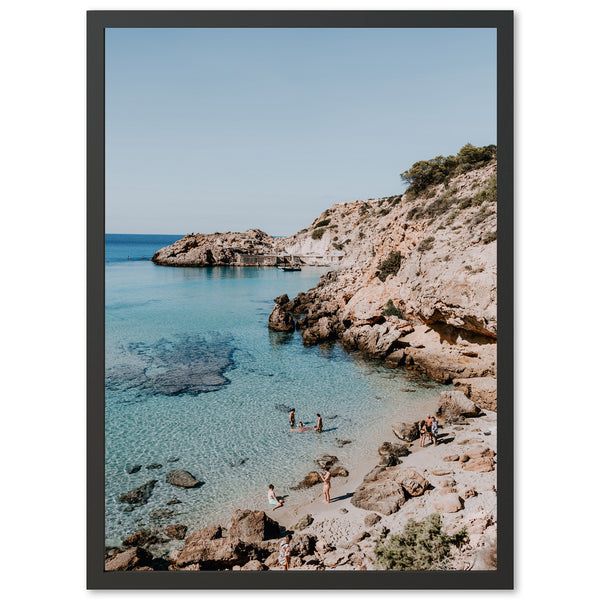 a picture of a beach with people swimming in the water