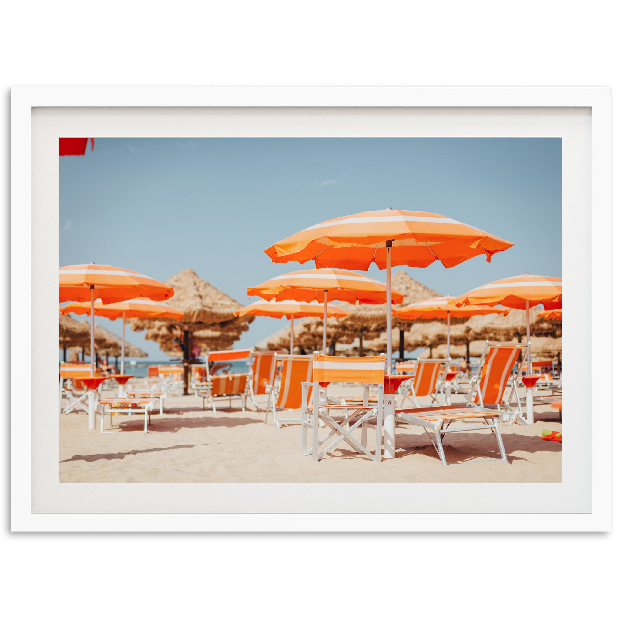 a bunch of chairs and umbrellas on a beach