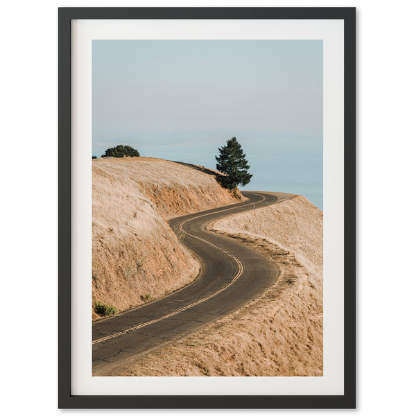 a picture of a dirt road going up a hill