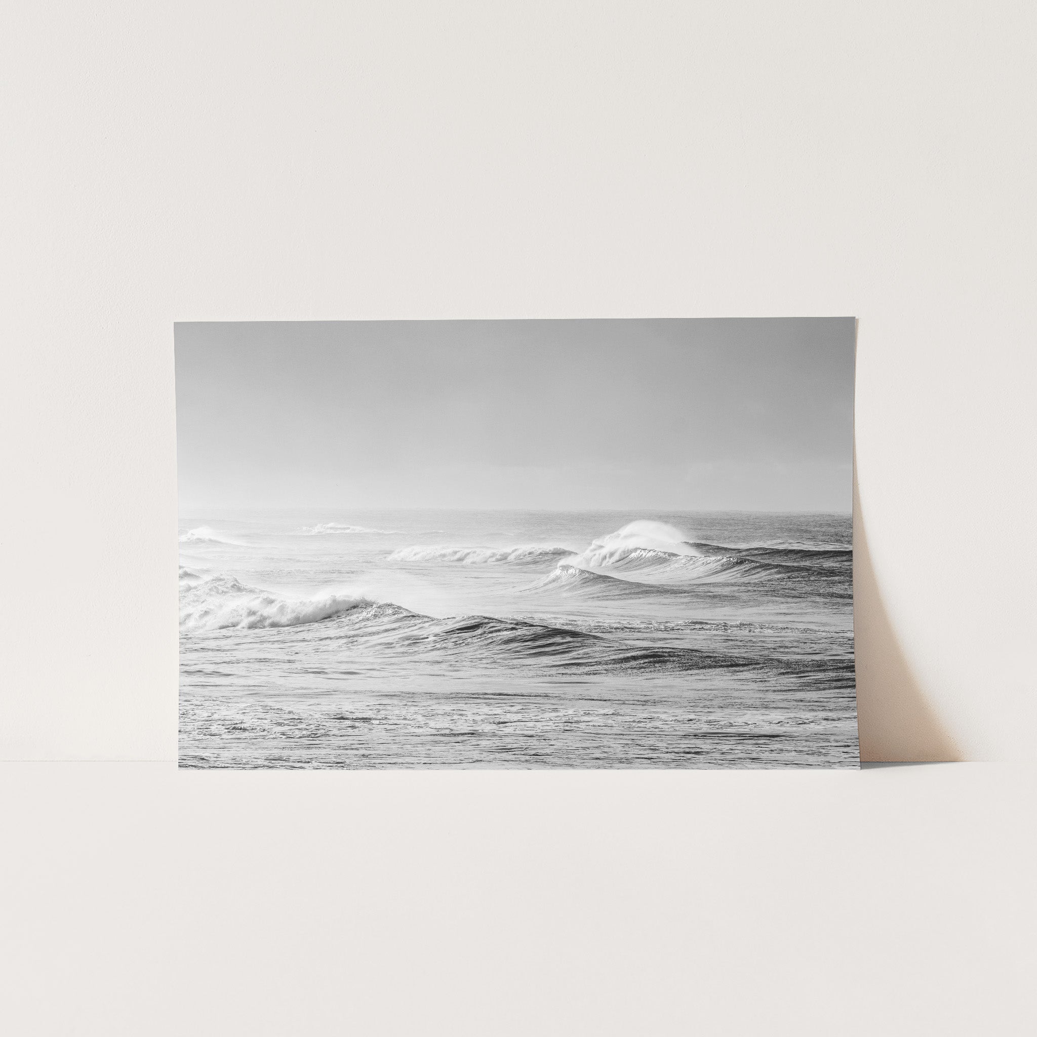 a black and white photo of a wave in the ocean