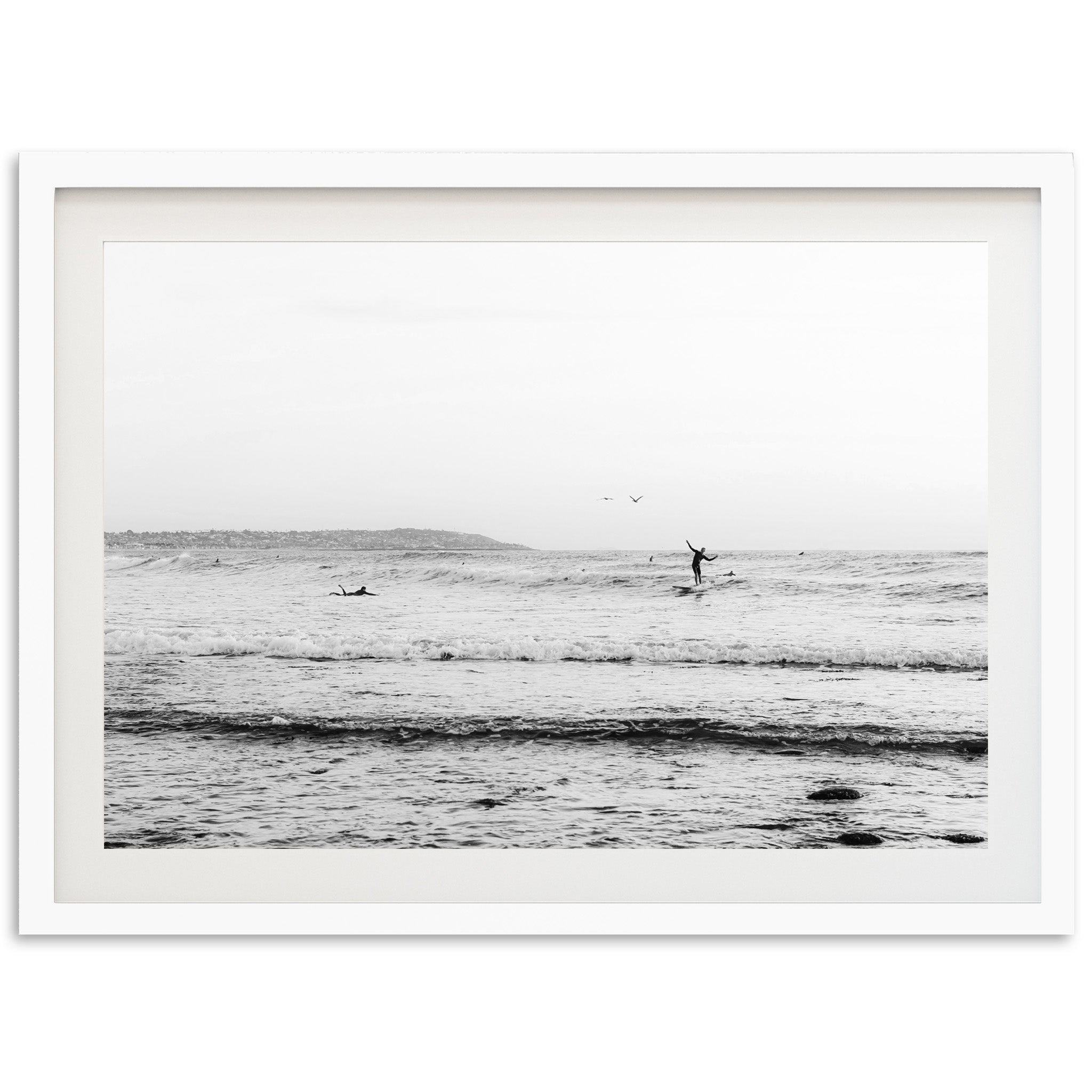 a black and white photo of a person on a surfboard