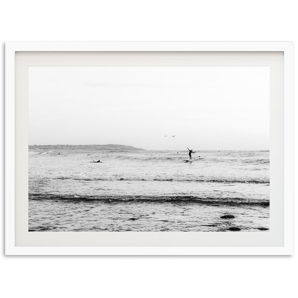 a black and white photo of a person on a surfboard