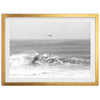 a black and white photo of a boat in the ocean