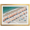 an aerial view of a beach with umbrellas and chairs