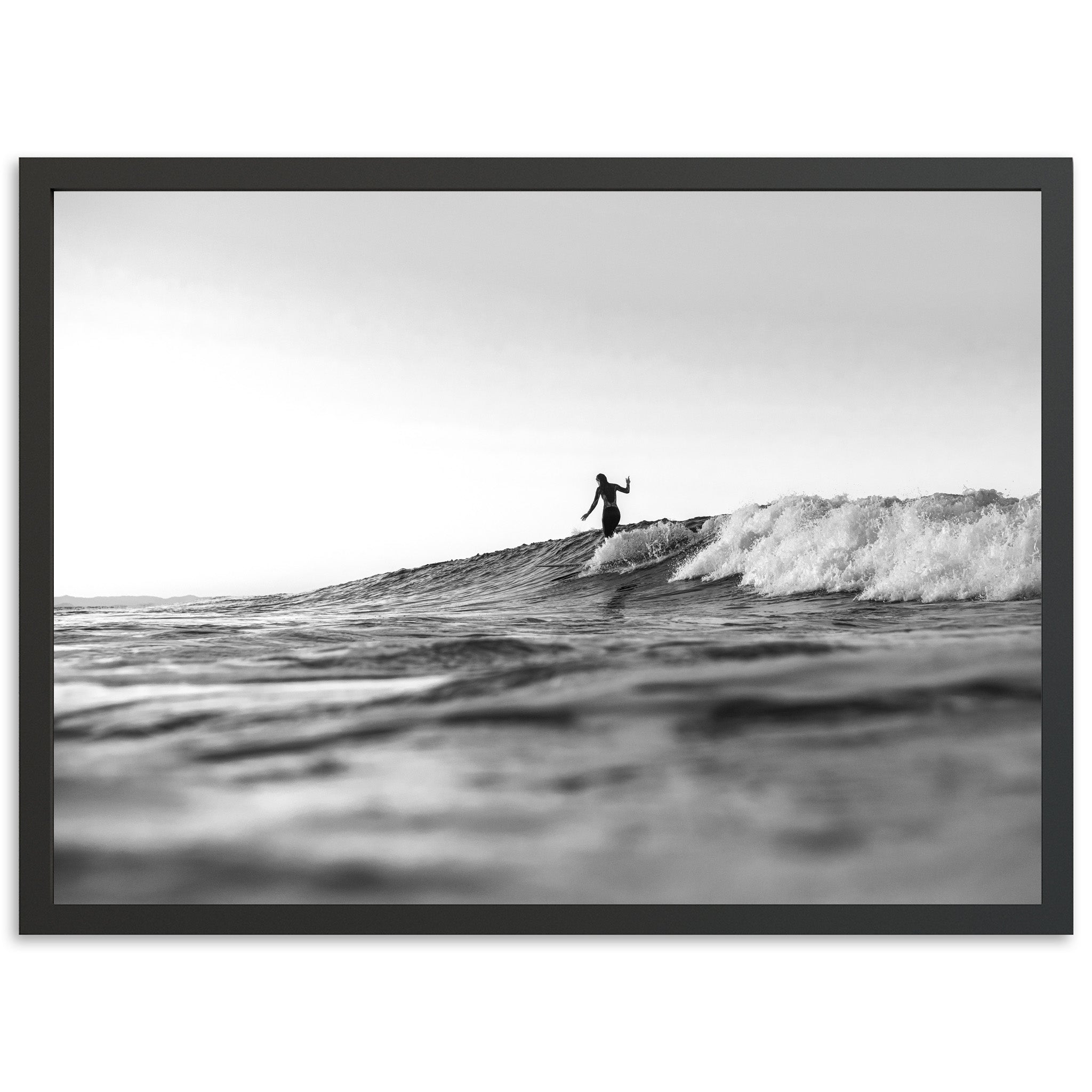 a man riding a wave on top of a surfboard