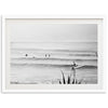 a black and white photo of surfers in the ocean