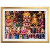 a group of colorful masks on display in a gold frame