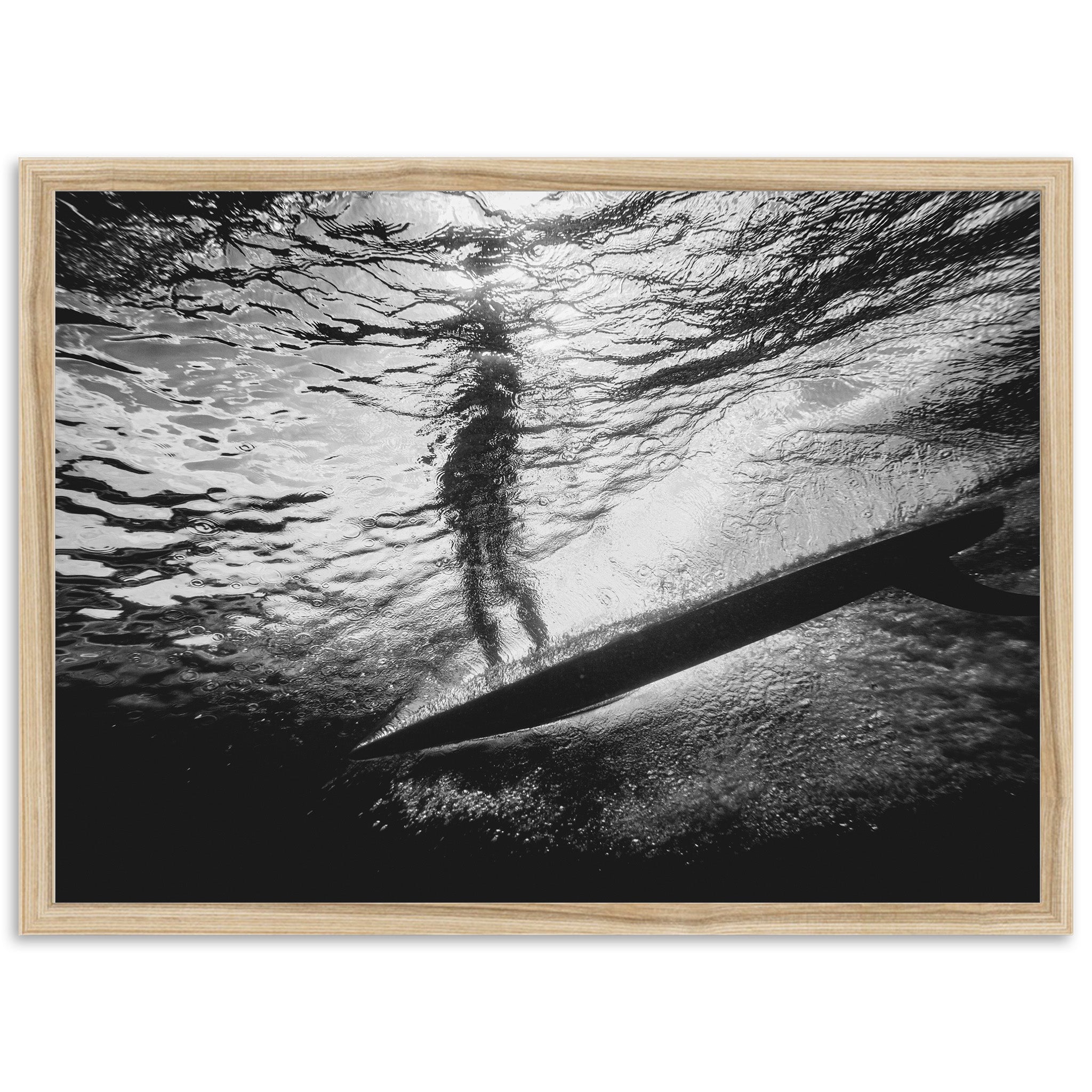 a black and white photo of a person on a surfboard