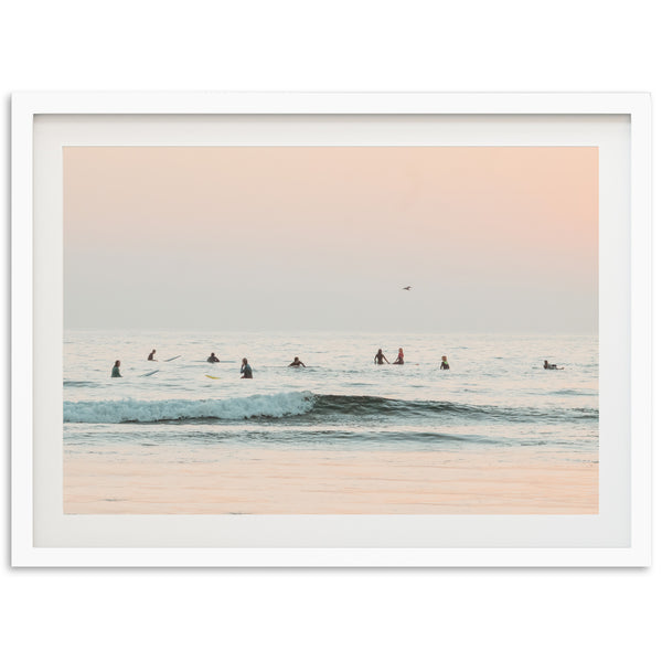 a group of people riding surfboards on top of a wave