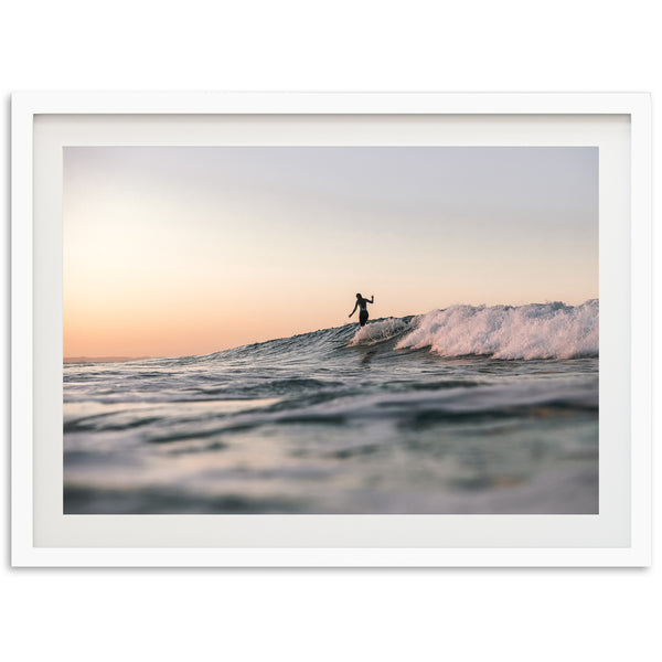 a man riding a wave on top of a surfboard