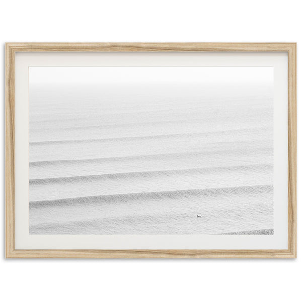 a picture of the ocean in a wooden frame