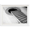 a black and white photo of an acoustic guitar