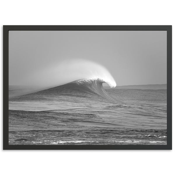 a black and white photo of a wave in the ocean