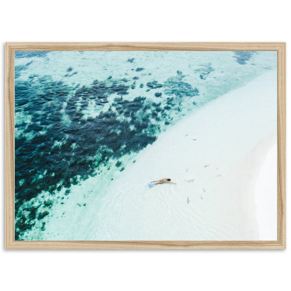 an aerial view of a beach with a boat in the water