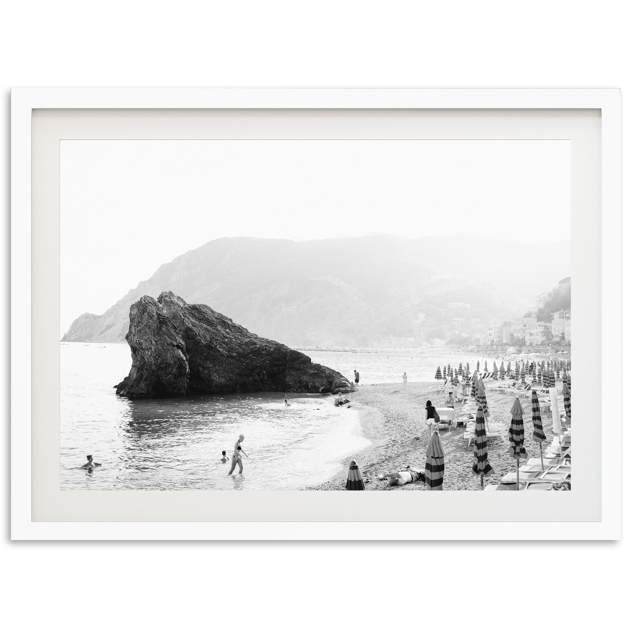 a black and white photo of people on a beach