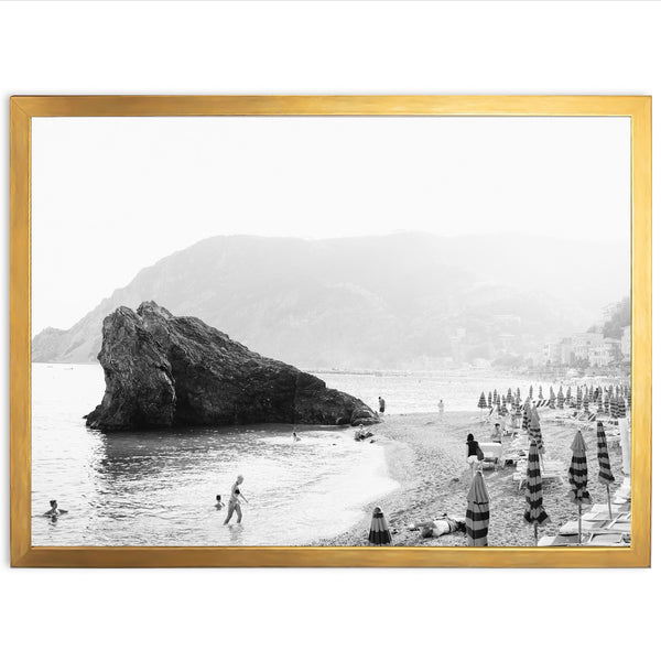 a black and white photo of people on a beach