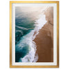 an aerial view of a beach with waves coming in