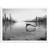 a black and white photo of a person diving into a lake