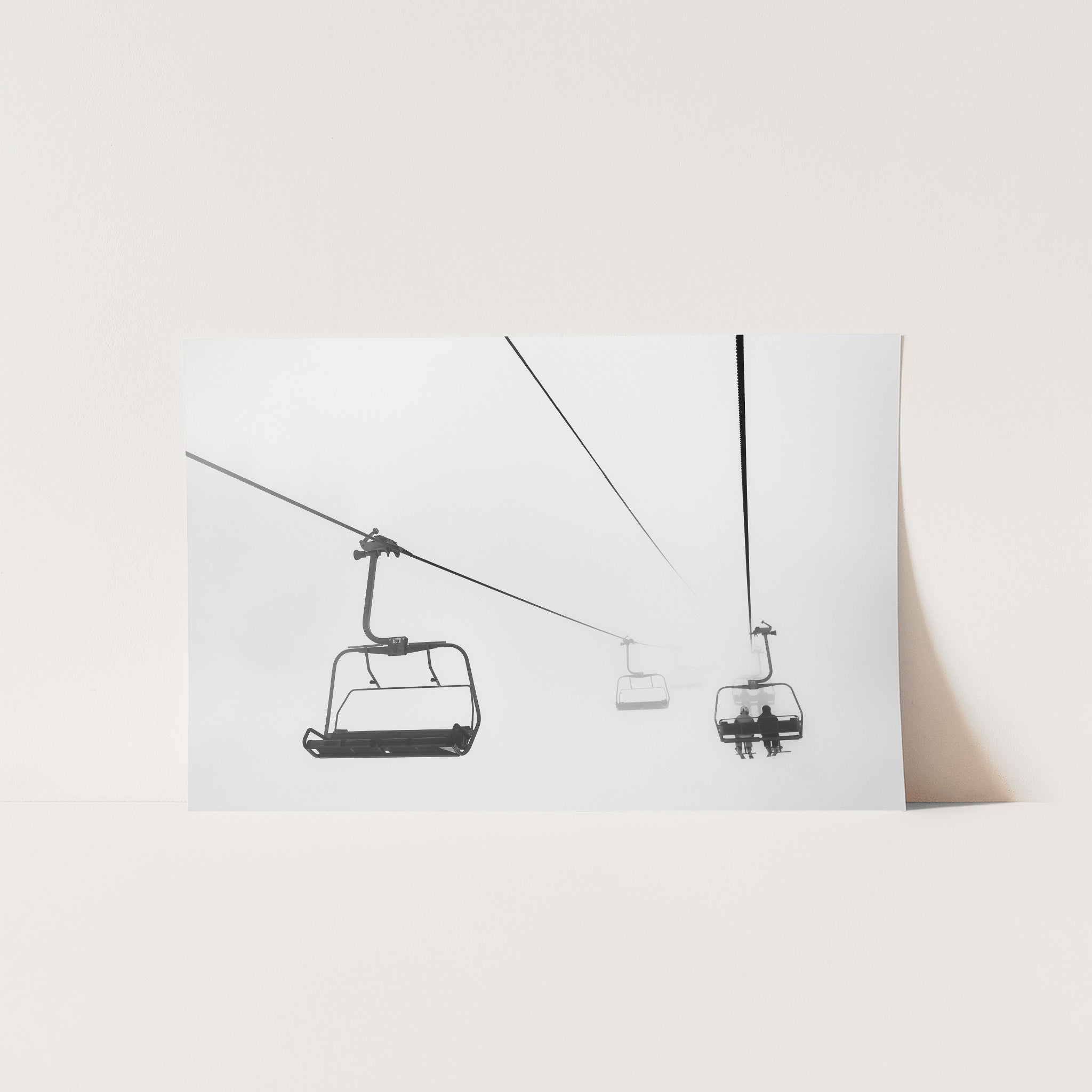 a black and white photo of a ski lift