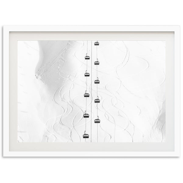 a white framed photograph of a ski lift