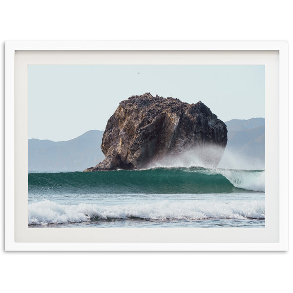 a picture of a rock in the middle of the ocean