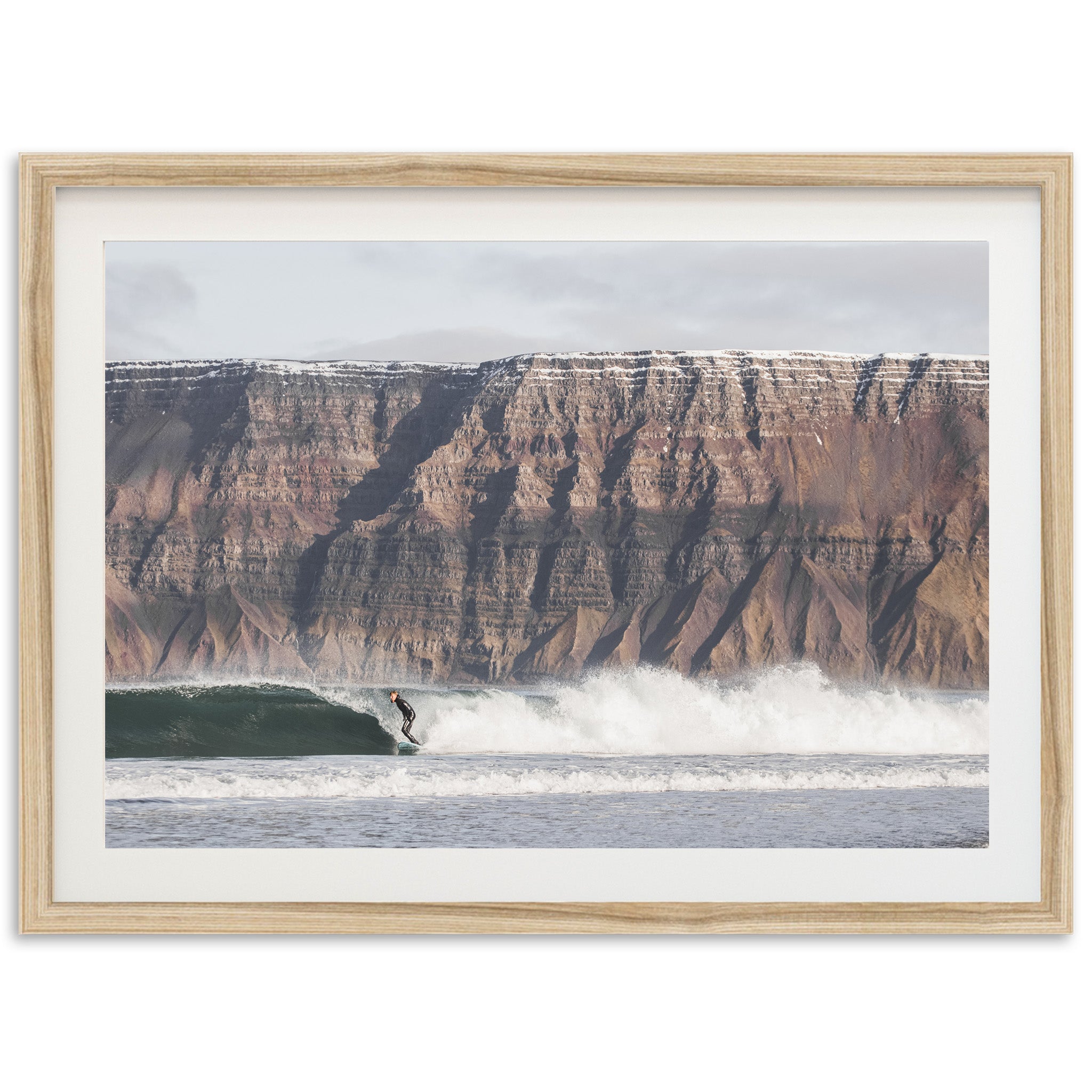 a man riding a wave on top of a surfboard