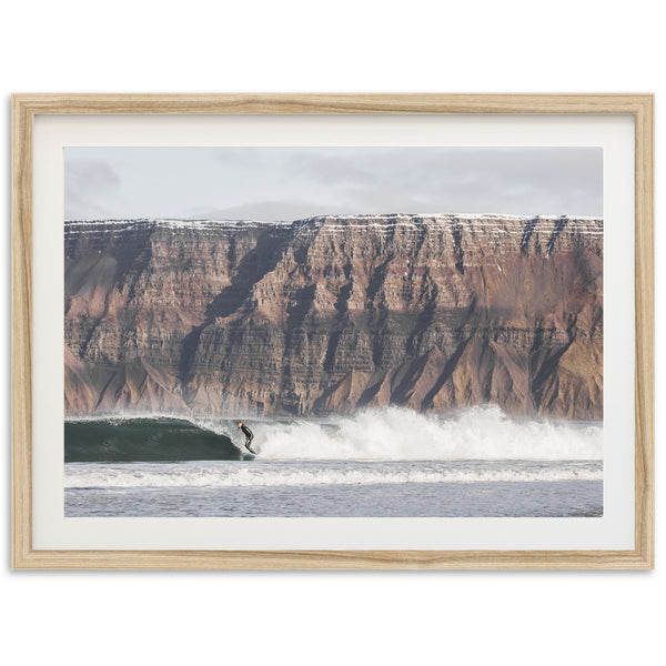 a man riding a wave on top of a surfboard