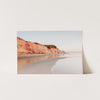 a picture of a beach with a cliff in the background