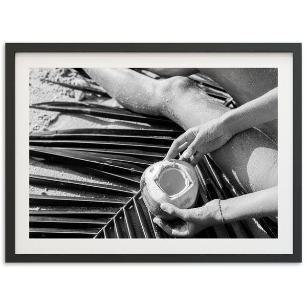 a black and white photo of a person holding a cup