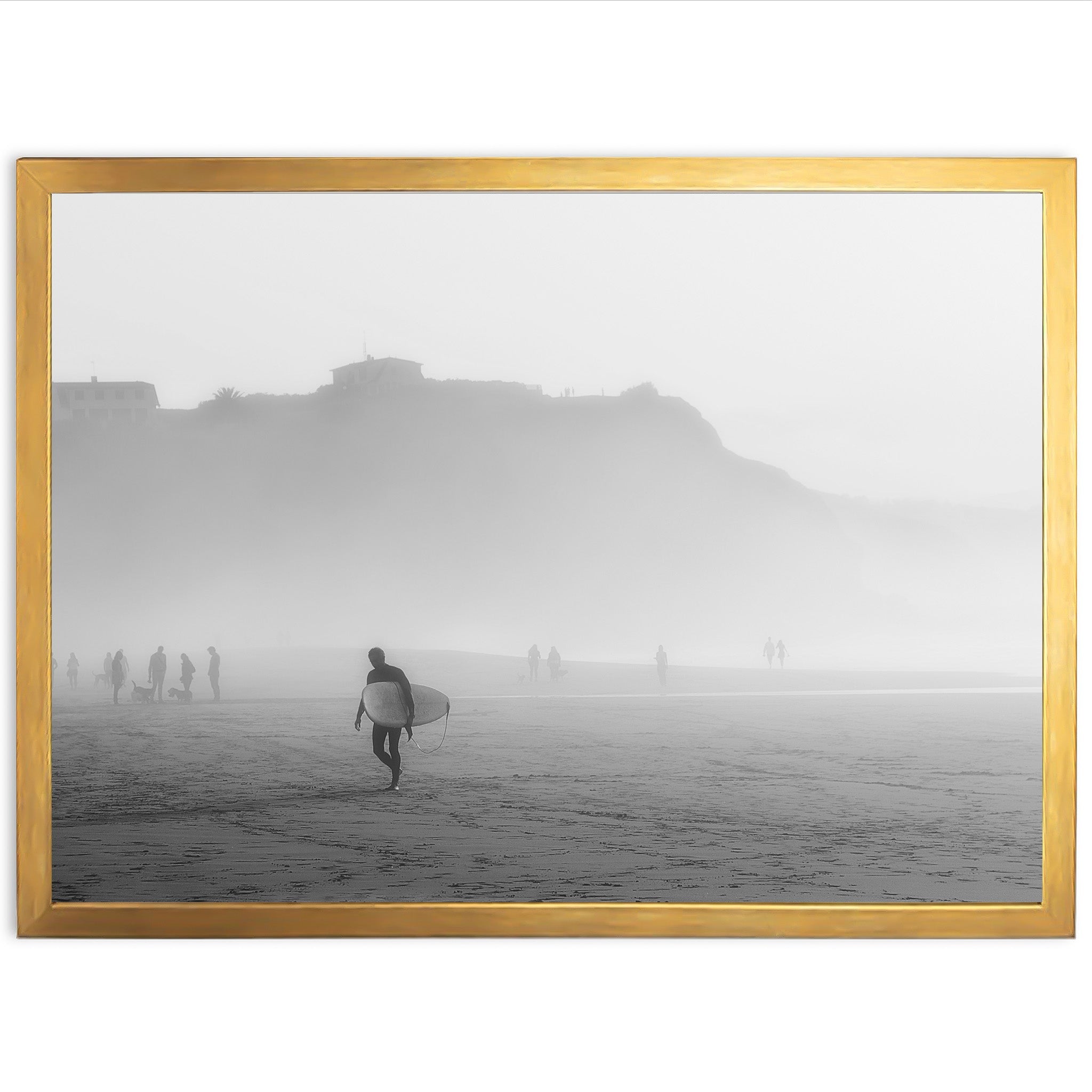 a black and white photo of a man carrying a surfboard