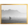 a black and white photo of a man carrying a surfboard